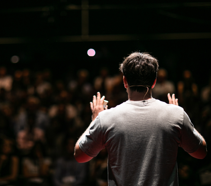 a person speaking to a crowd, events page