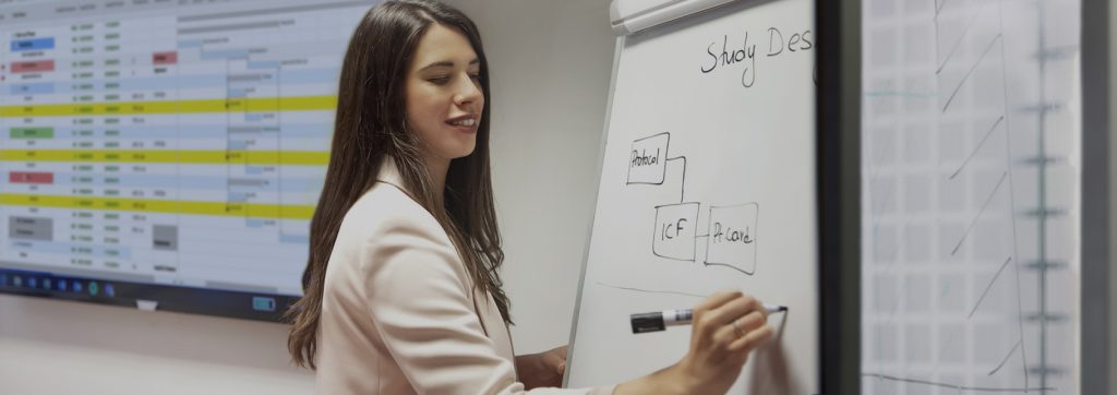 a woman writing on a board